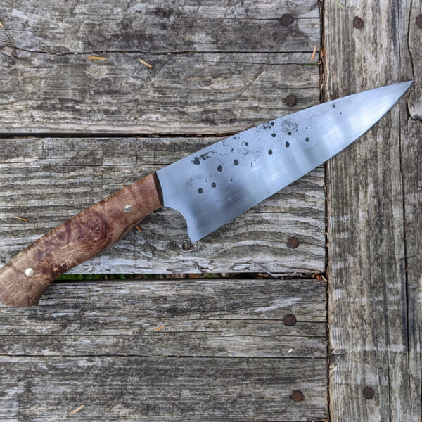 Profile view of a chef knife.