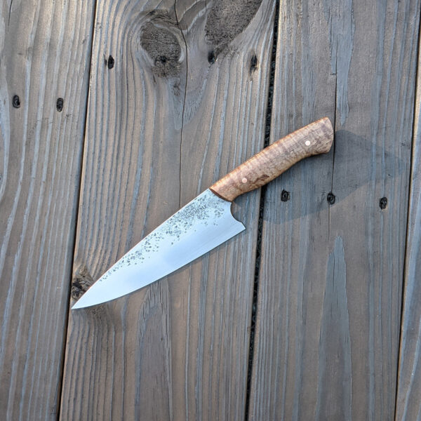 Profile view of a chef knife.