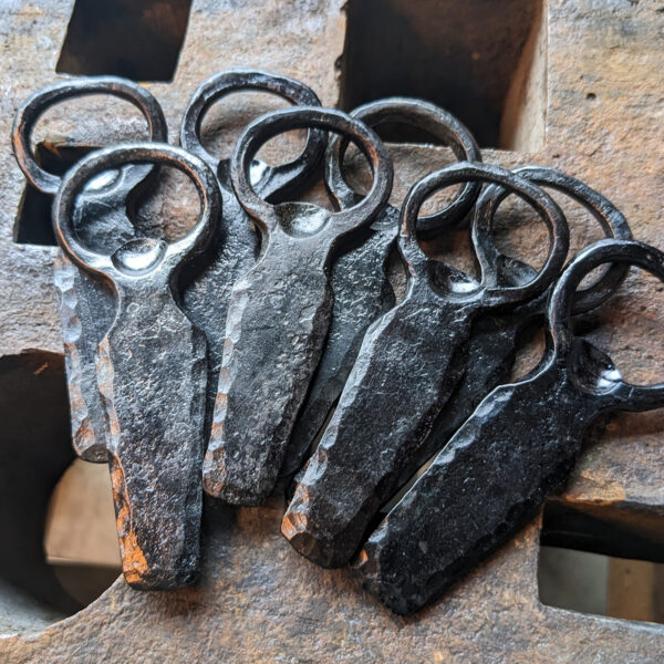 A pile of forged bottle openers.