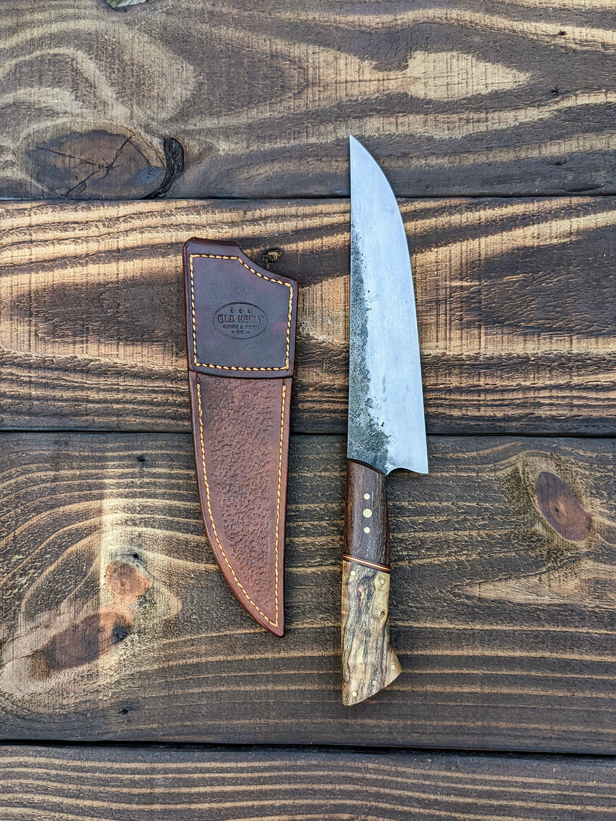 Side by side view of chef knife and a leather scabbard.