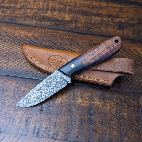 A Heeler knife in damascus with a koa handle.