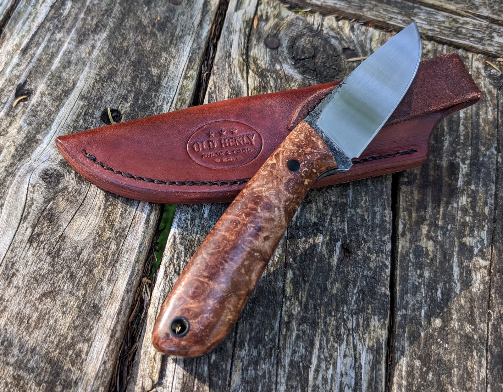 A Heeler knife model with a maple burl handle.