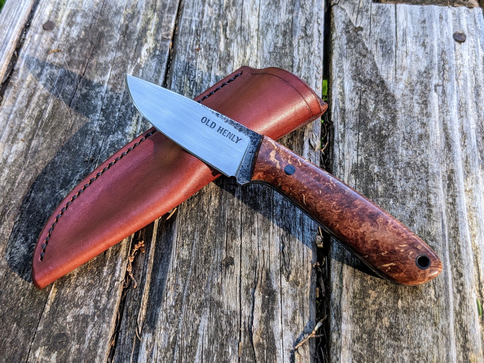 A Heeler knife model with a maple burl handle.